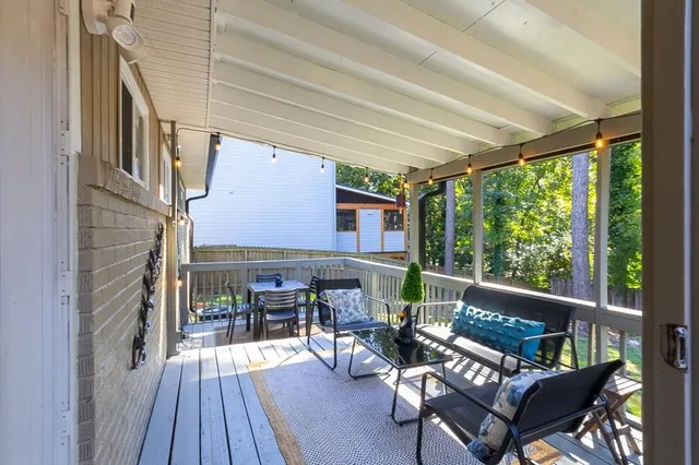 a view of a swimming pool with a patio and wooden fence