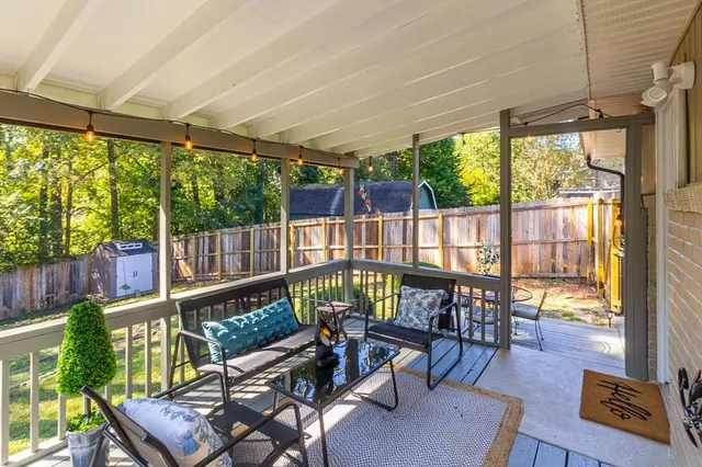 a view of swimming pool with wooden fence