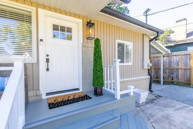 a view of a house with a yard and sitting space
