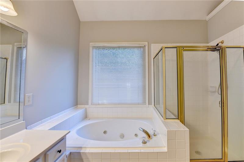 655 Golden Meadows Lane Suwanee, GA 30024 - Photo 35 of 73 a bathroom with a tub and a sink