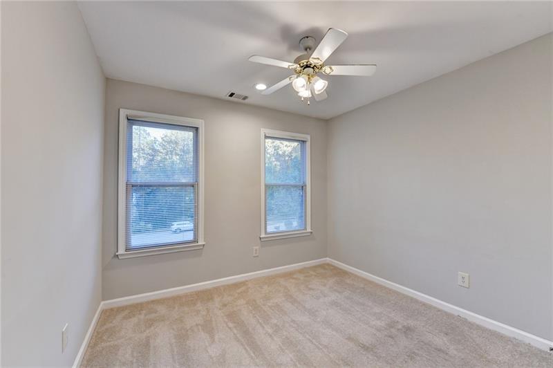 655 Golden Meadows Lane Suwanee, GA 30024 - Photo 43 of 73 an empty room with windows and fan