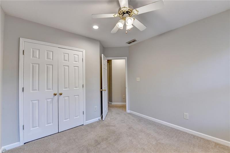 655 Golden Meadows Lane Suwanee, GA 30024 - Photo 45 of 73 an empty room with a chandelier fan