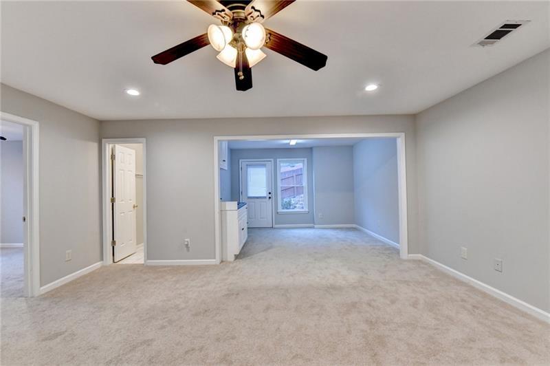 655 Golden Meadows Lane Suwanee, GA 30024 - Photo 47 of 73 a view of a livingroom with a ceiling fan and window