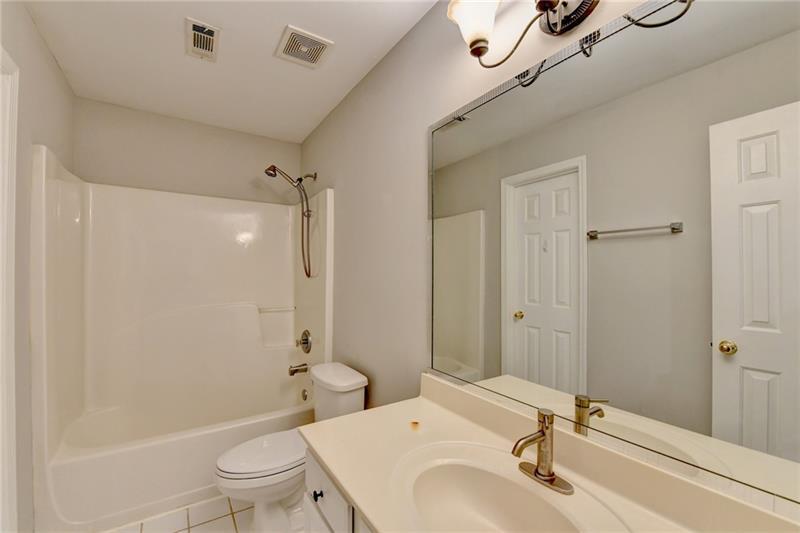 655 Golden Meadows Lane Suwanee, GA 30024 - Photo 54 of 73 a bathroom with a sink a toilet and shower