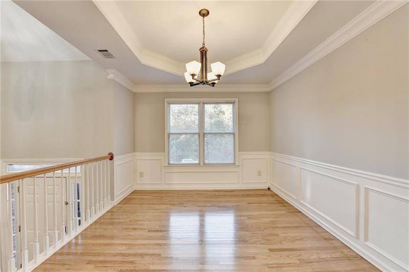 655 Golden Meadows Lane Suwanee, GA 30024 - Photo 7 of 73 a view of an empty room with wooden floor and a window