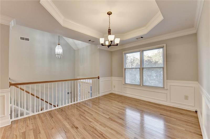 655 Golden Meadows Lane Suwanee, GA 30024 - Photo 8 of 73 a view of a room with wooden floor chandelier and entryway
