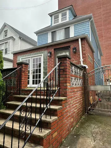 a front view of a house with iron stairs