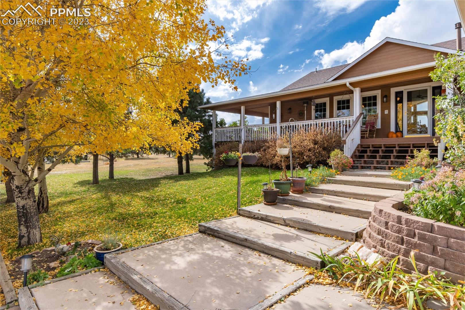 16850 Steppler Road Colorado Springs, CO 80908 - Photo 1 of 36 Welcome to the ranch- color and landscaping abound.