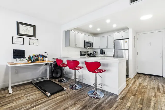 a kitchen with a refrigerator and a sink