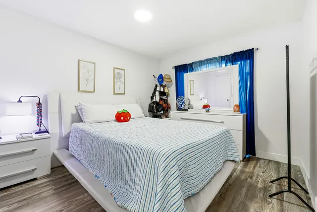 a bed room with a bed and a large mirror