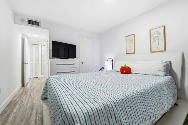 a bedroom with a bed and a flat screen tv