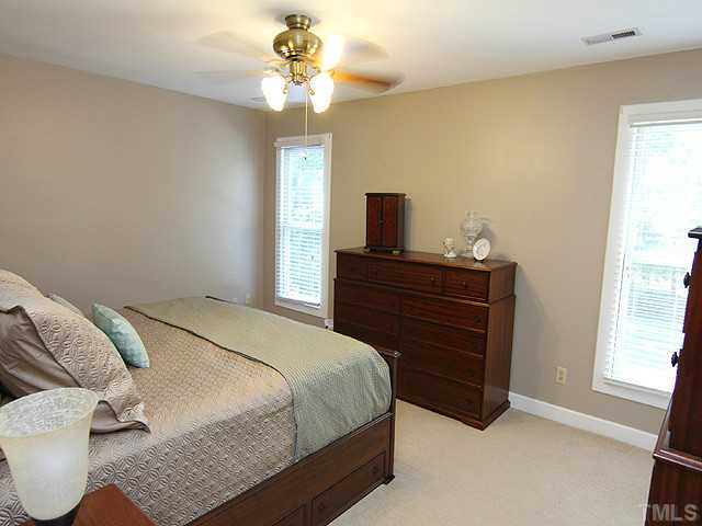 8312 Kestrel Drive Raleigh, NC 27615 - Photo 16 of 24 BEAUTIFUL BRIGHT PORCH WITH WALL OF WINDOWS OVERLOOKS DECK AND LANDSCAPED YARD
