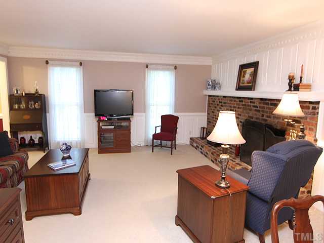 HANDSOME RAISED PANELS AROUND WALLS AND FIREPLACE AND CRISP PROFILE OF CROWN MOLDING PROVIDES WARMTH AND BEAUTY TO THIS CLASSIC ROOM