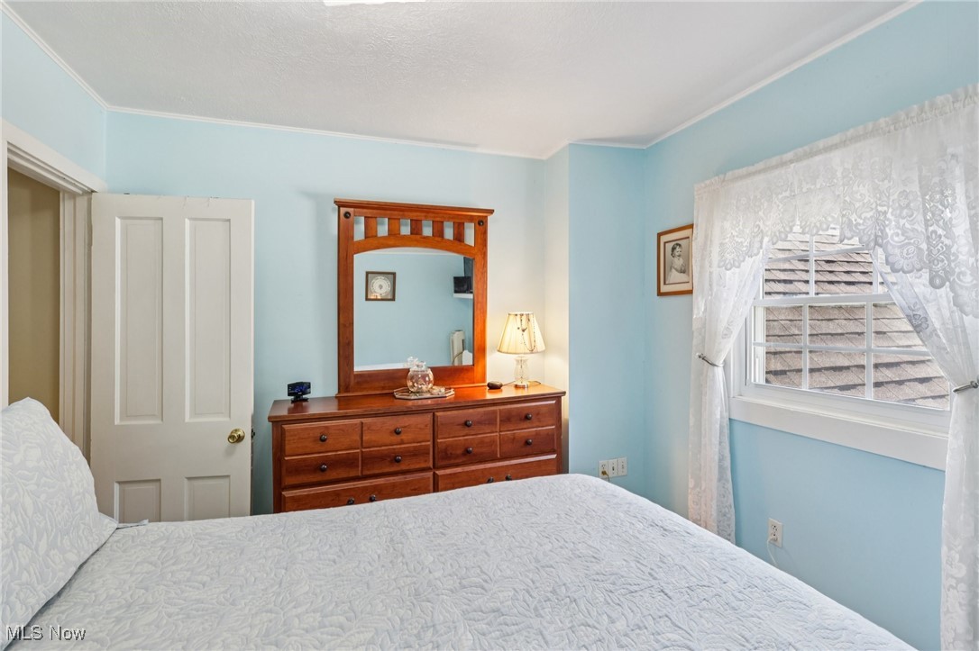 10818 Dixon Road Cleveland, OH 44111 - Photo 35 of 44 Bedroom with crown molding