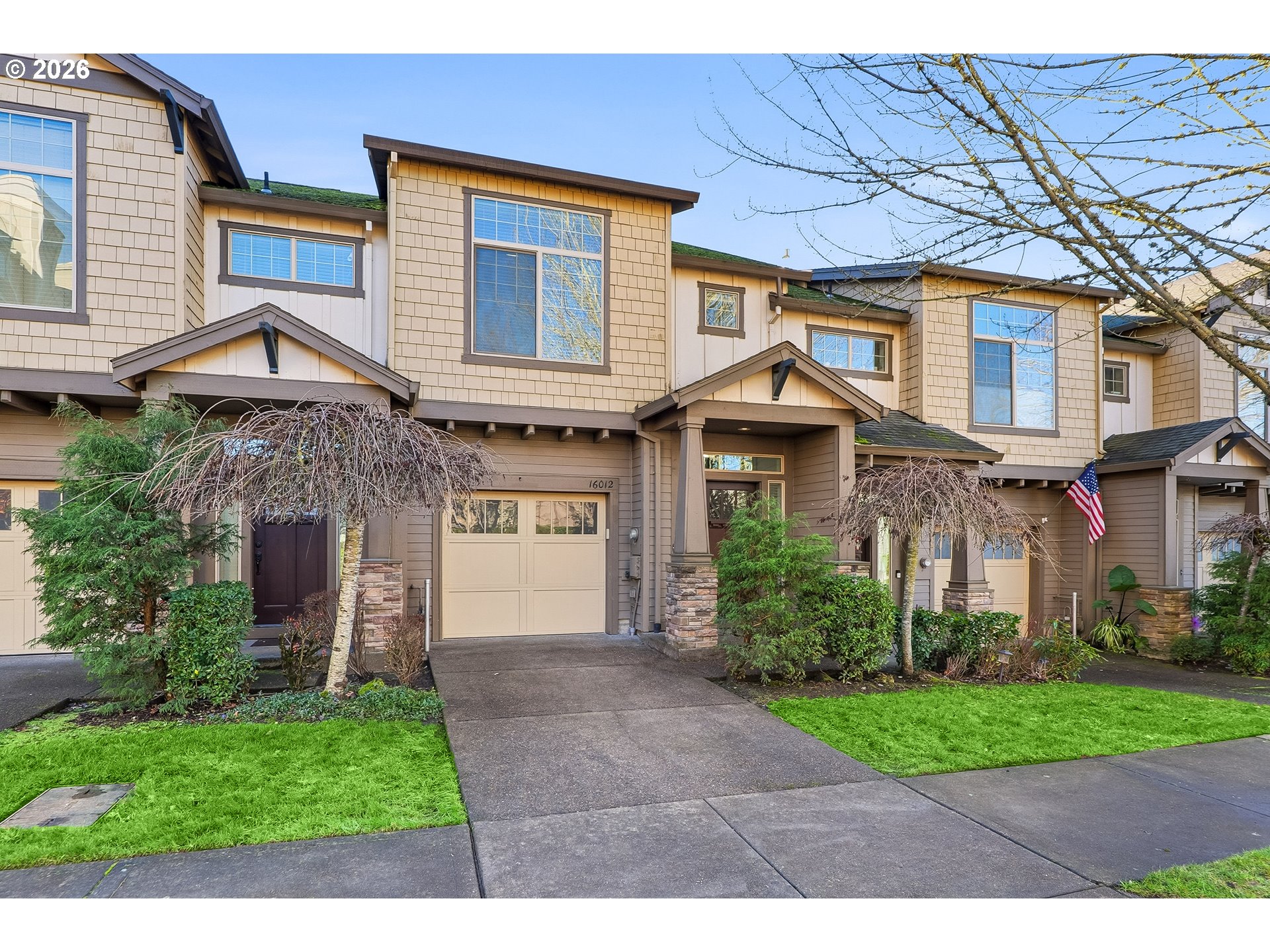 16012 Northwest Centine Lane Portland, OR 97229 - Photo 1 of 24 a front view of a house with a garden and plants