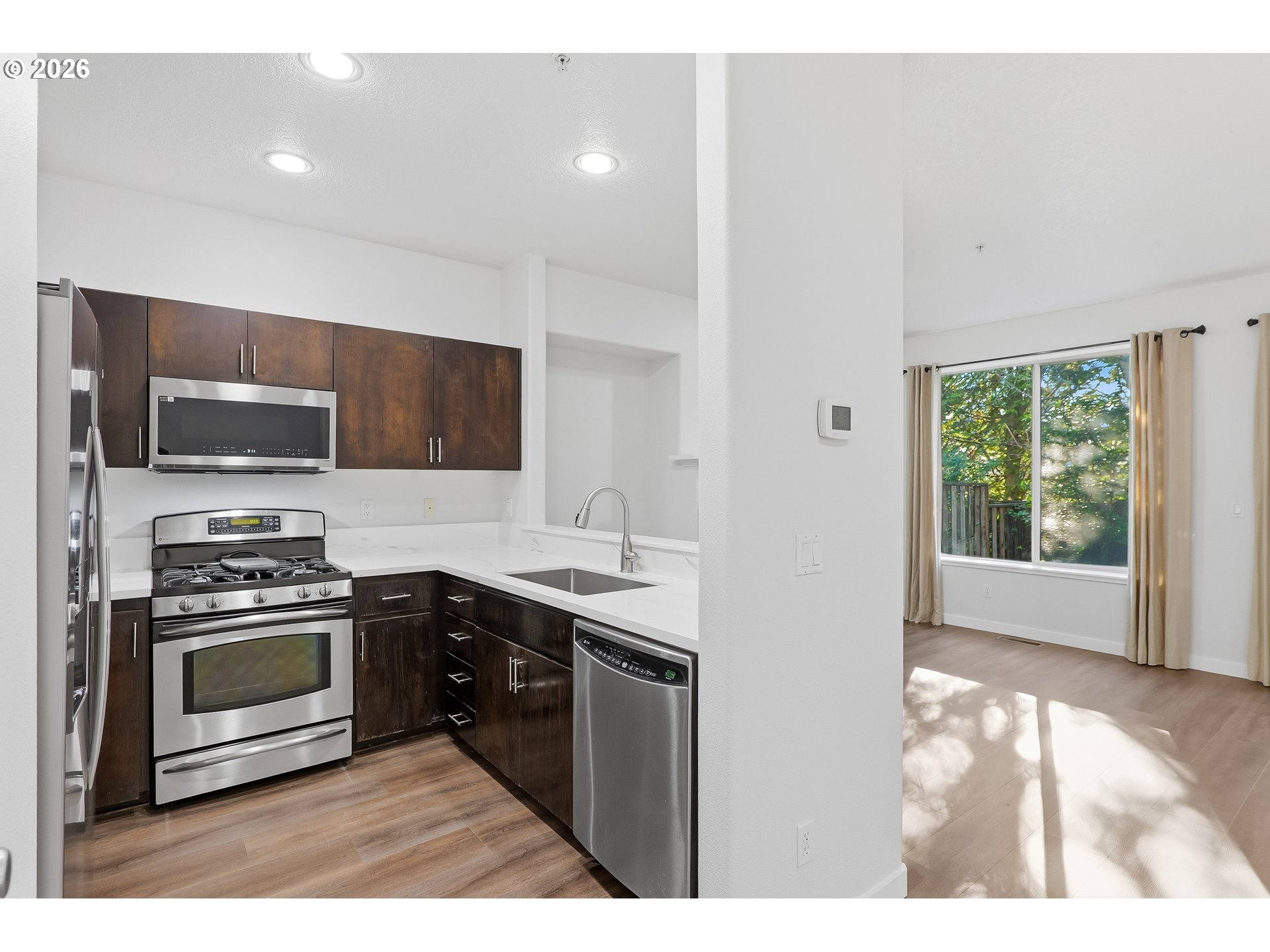16012 Northwest Centine Lane Portland, OR 97229 - Photo 11 of 24 a kitchen with stainless steel appliances granite countertop a stove a sink and a microwave