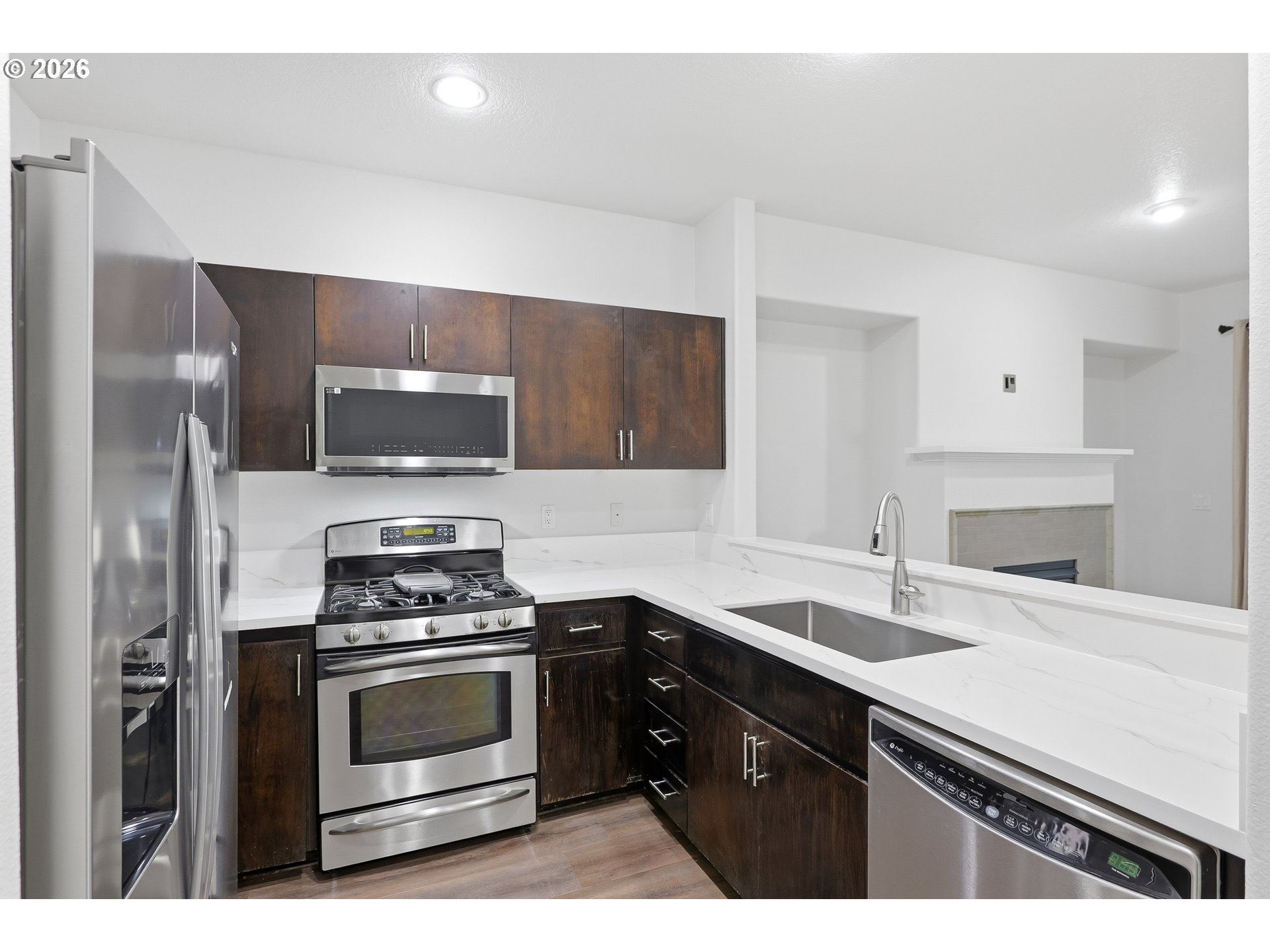 16012 Northwest Centine Lane Portland, OR 97229 - Photo 12 of 24 a kitchen with a sink and stainless steel appliances