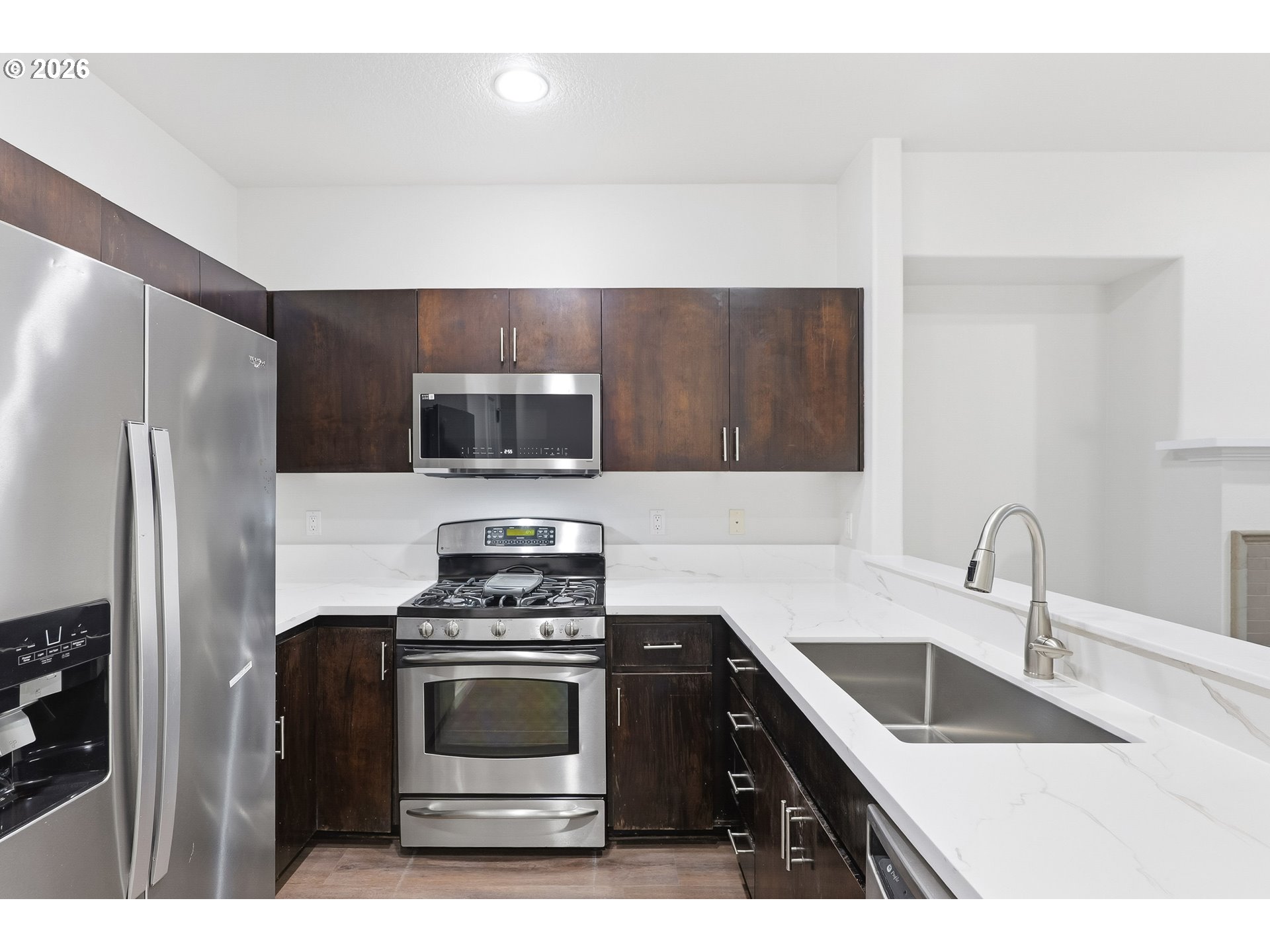 16012 Northwest Centine Lane Portland, OR 97229 - Photo 13 of 24 a kitchen with a sink stove and microwave