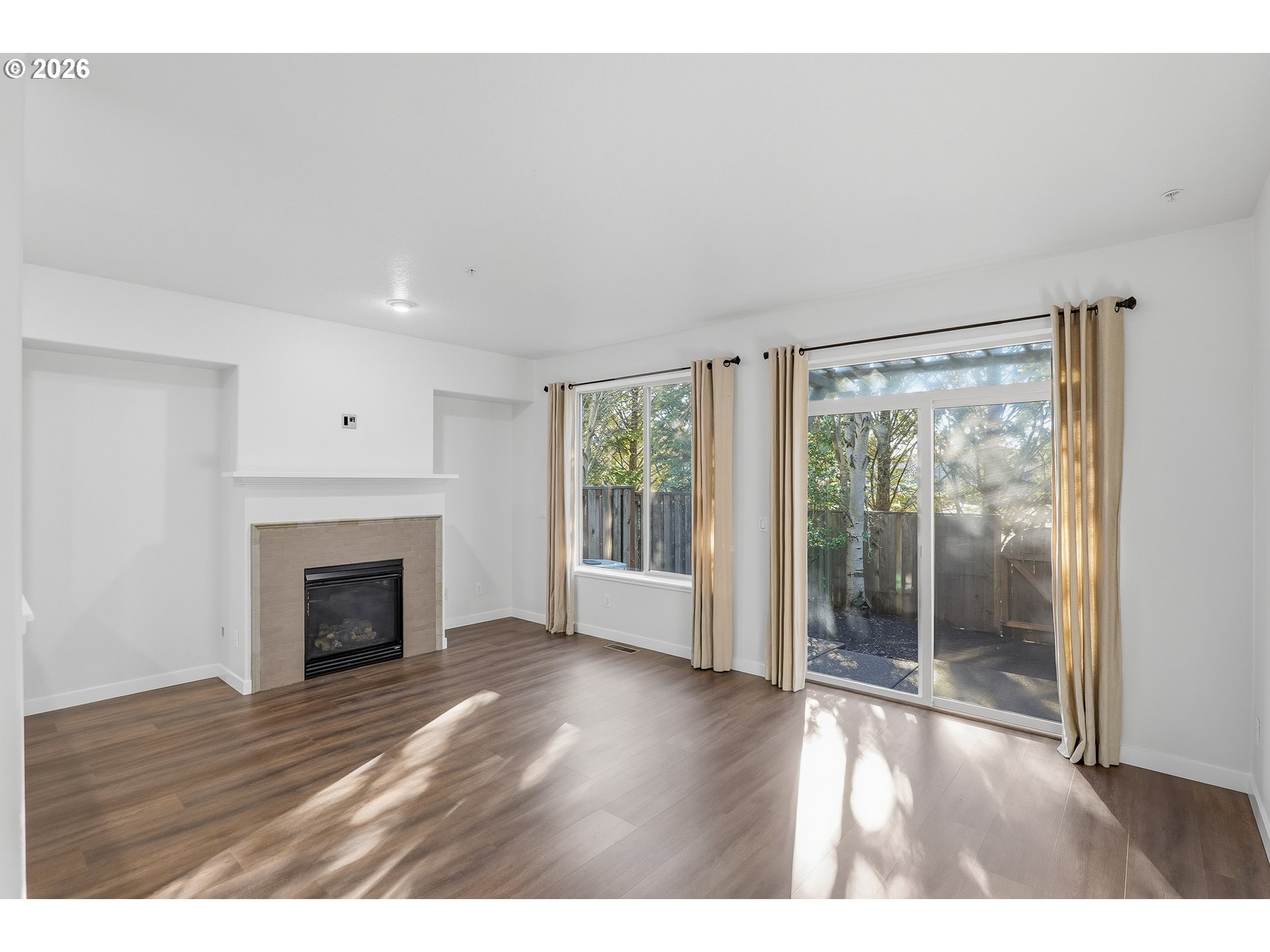 16012 Northwest Centine Lane Portland, OR 97229 - Photo 8 of 24 a view of empty room with wooden floor and fireplace