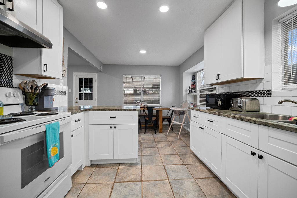 2302 Memorial Parkway Portland, TX 78374 - Photo 11 of 21 a kitchen with white cabinets and appliances