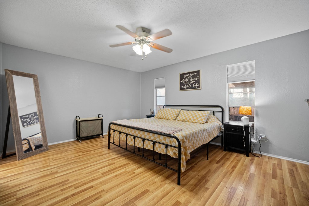 2302 Memorial Parkway Portland, TX 78374 - Photo 12 of 21 a spacious bedroom with a bed and a flat tv screen on dresser