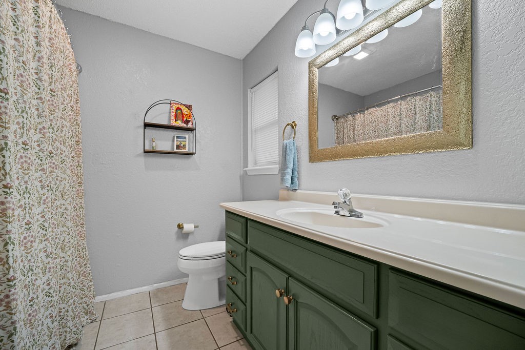 2302 Memorial Parkway Portland, TX 78374 - Photo 14 of 21 a bathroom with a toilet sink and mirror