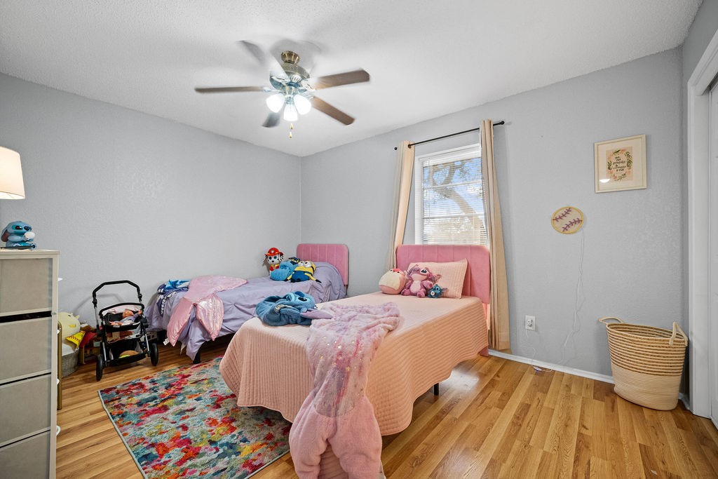 2302 Memorial Parkway Portland, TX 78374 - Photo 16 of 21 a bedroom with a bed and wooden floor