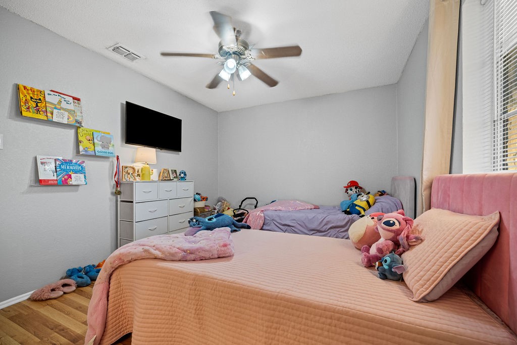 2302 Memorial Parkway Portland, TX 78374 - Photo 17 of 21 a bedroom with a bed and flat screen tv