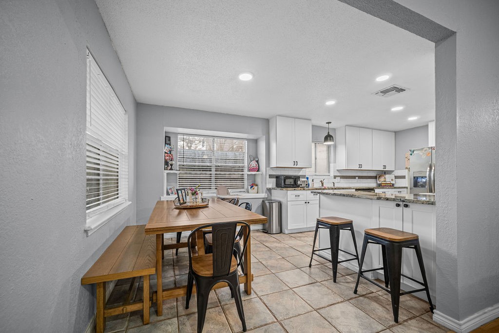 2302 Memorial Parkway Portland, TX 78374 - Photo 8 of 21 a dining room with kitchen island a table and chairs
