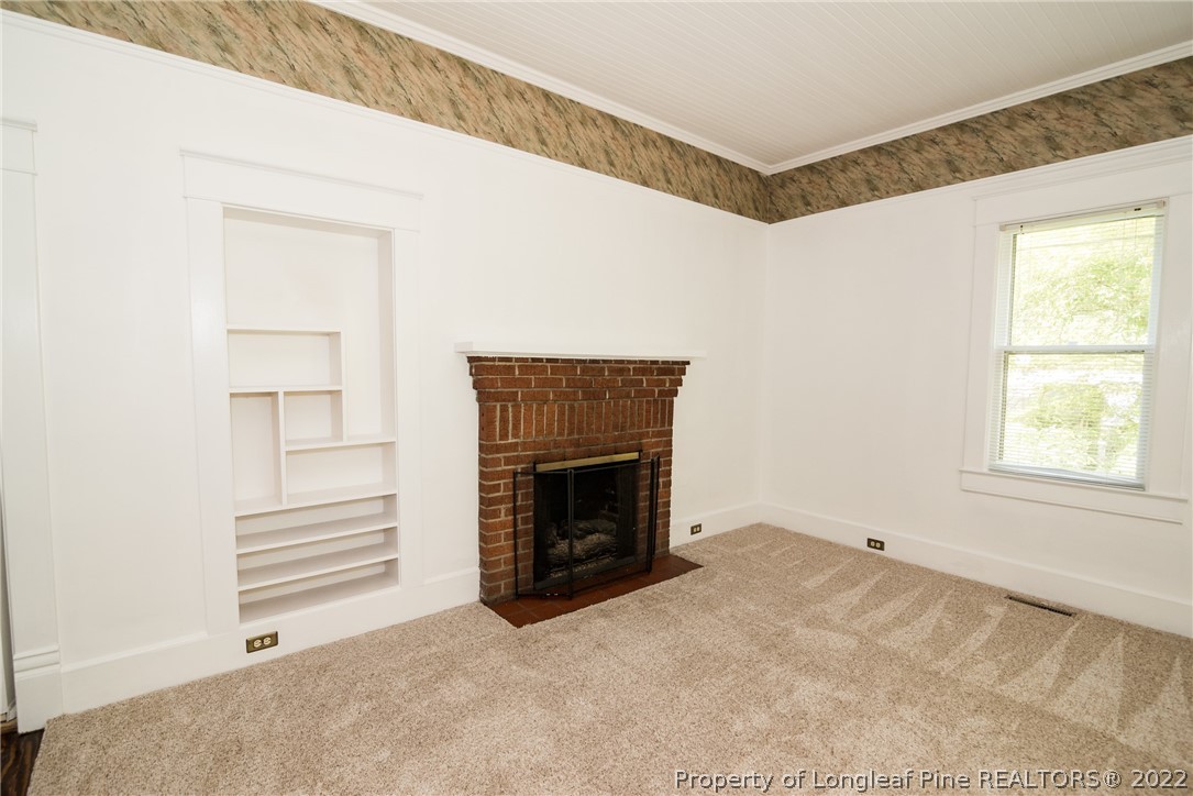 3316 Old River Road Carthage, NC 28327 - Photo 14 of 35 a view of empty room with a fireplace and window
