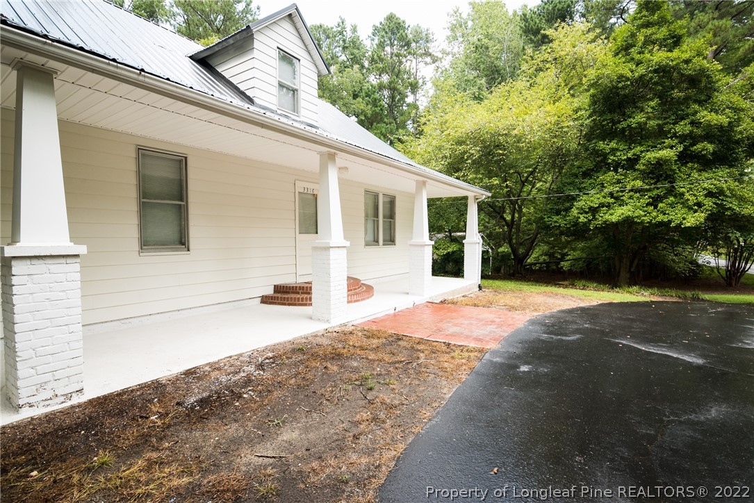 3316 Old River Road Carthage, NC 28327 - Photo 2 of 35 a front view of a house with yard and trees