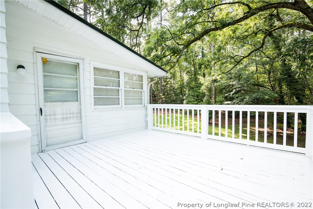 3316 Old River Road Carthage, NC 28327 - Photo 33 of 35 a view of a balcony with a floor to ceiling window and wooden fence