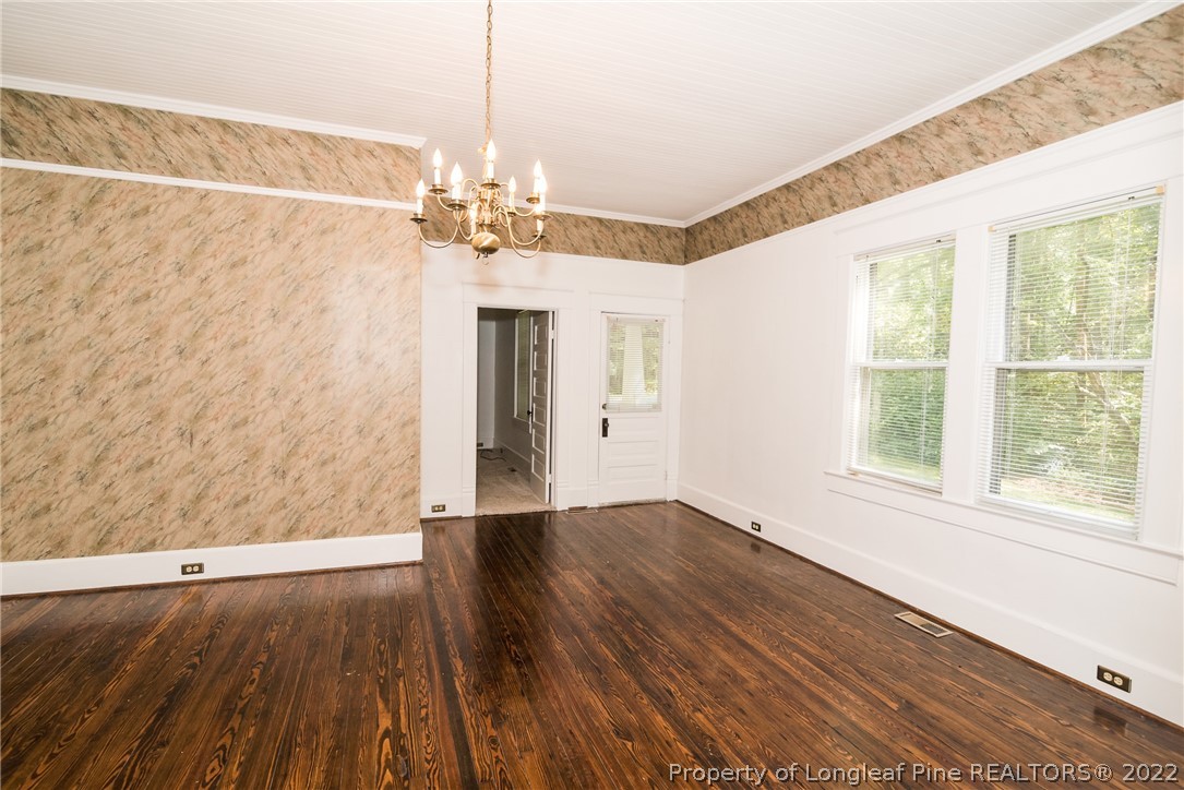 3316 Old River Road Carthage, NC 28327 - Photo 7 of 35 a view of a livingroom with wooden floor and a chandelier
