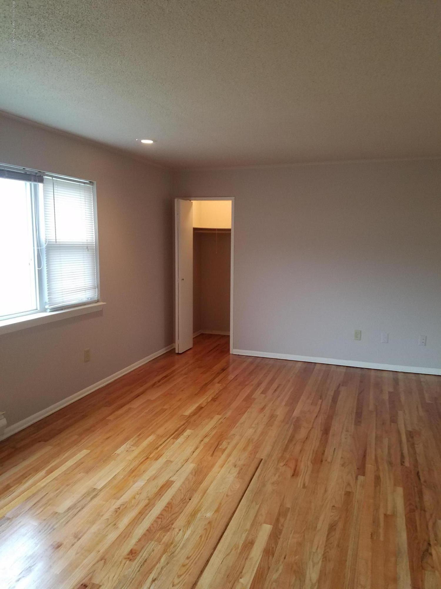 2 Sutton Drive, Unit P04 Matawan, NJ 07747 - Photo 1 of 8 an empty room with wooden floor and windows