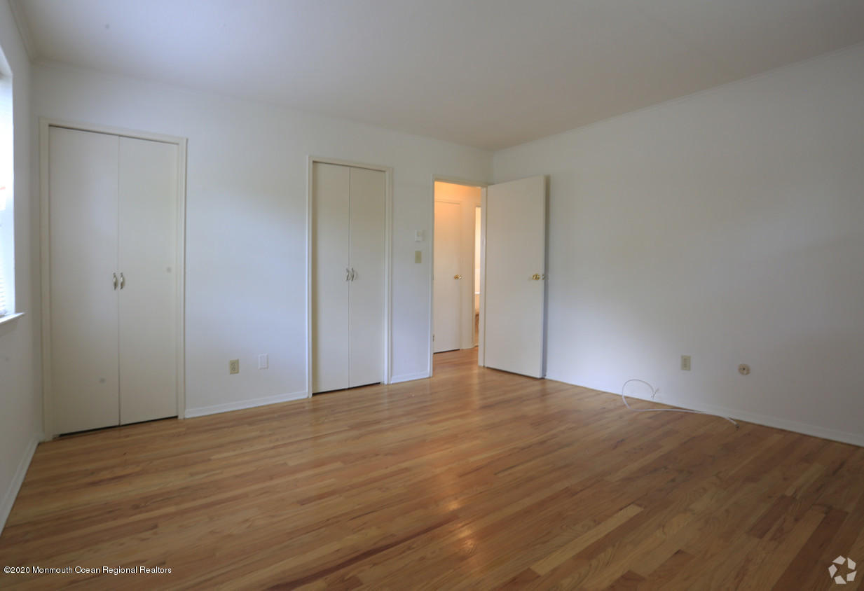 2 Sutton Drive, Unit P04 Matawan, NJ 07747 - Photo 4 of 8 a view of an empty room and wooden floor