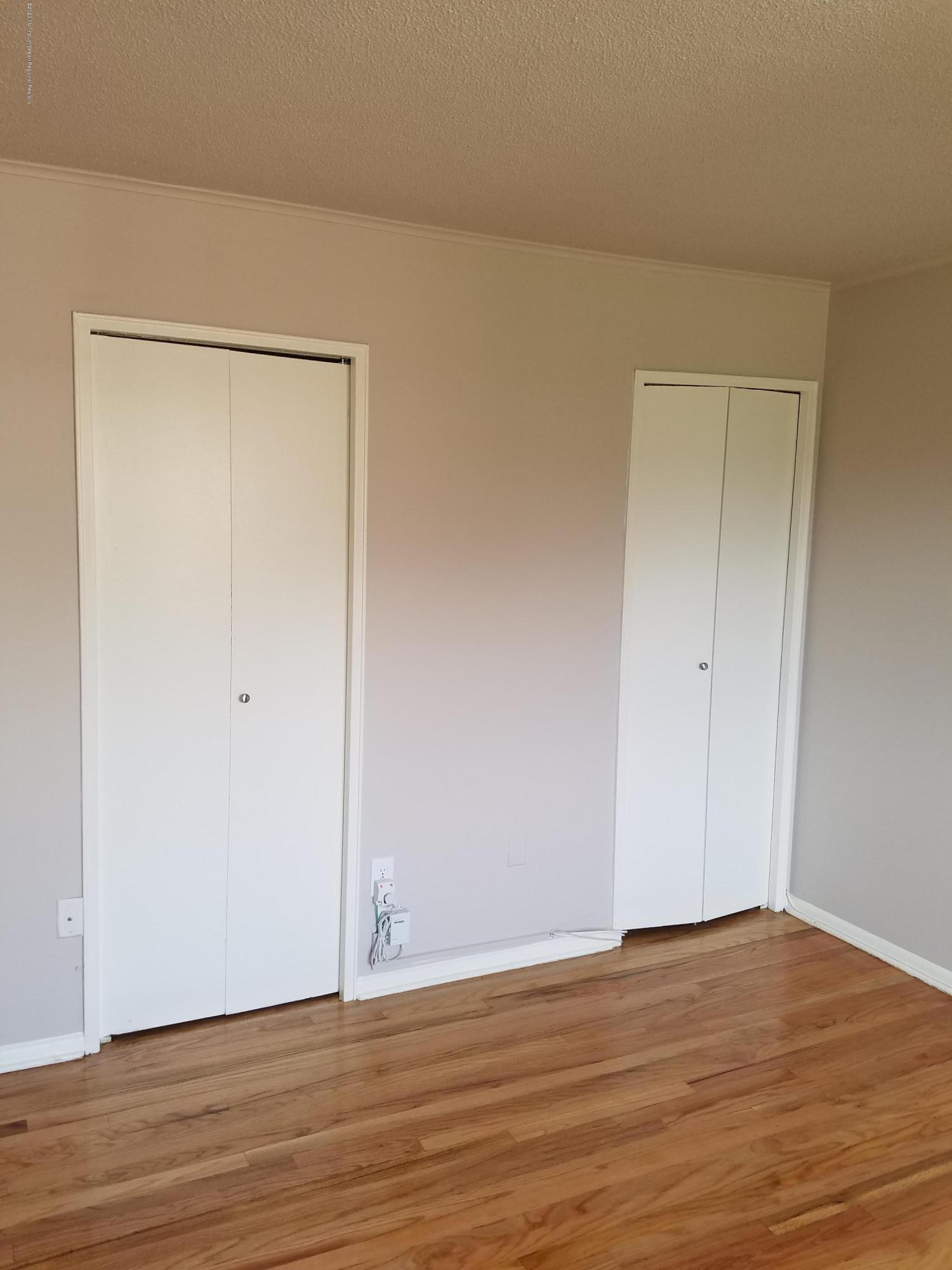 2 Sutton Drive, Unit P04 Matawan, NJ 07747 - Photo 5 of 8 a view of an empty room with wooden floor