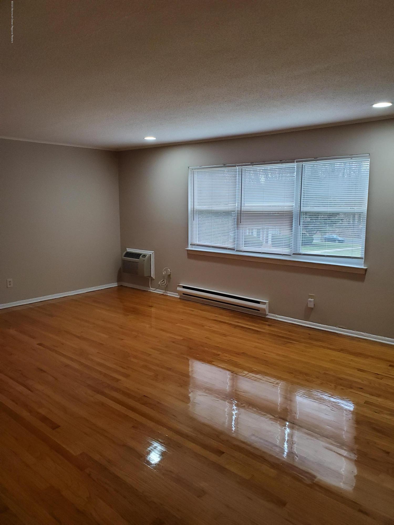 2 Sutton Drive, Unit P04 Matawan, NJ 07747 - Photo 8 of 8 a view of empty room with wooden floor and fan