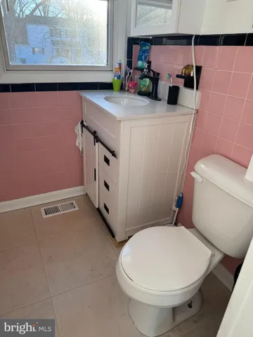 a bathroom with a sink a toilet and a shower curtain