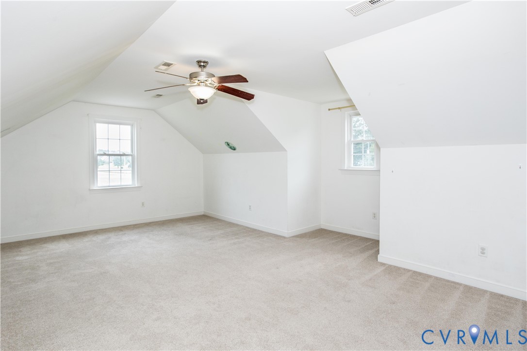 20411 Horseshoe Road Carson, VA 23830 - Photo 27 of 35 Carpeted room with a ceiling fan, two windows, and
