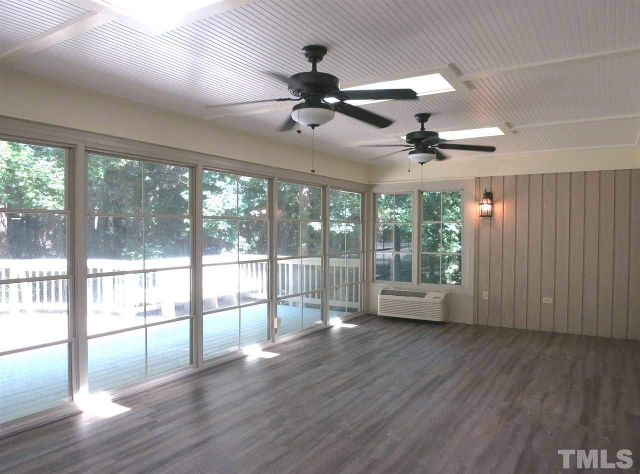 9209 Litchford Road Raleigh, NC 27615 - Photo 11 of 25 a view of an empty room with wooden floor and a window