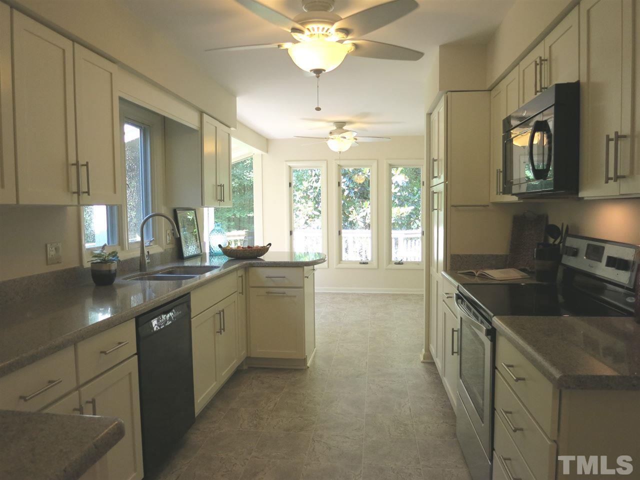 9209 Litchford Road Raleigh, NC 27615 - Photo 12 of 25 a kitchen with granite countertop a sink and white cabinets