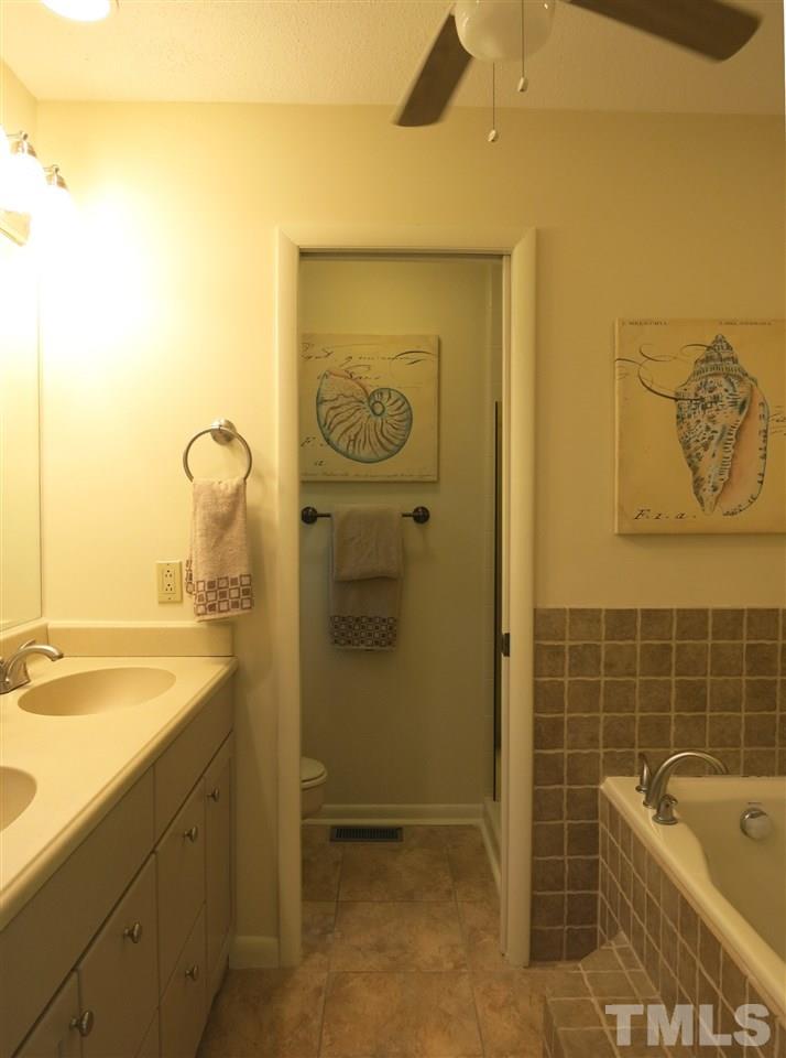 9209 Litchford Road Raleigh, NC 27615 - Photo 16 of 25 a bathroom with a tub sink and mirror