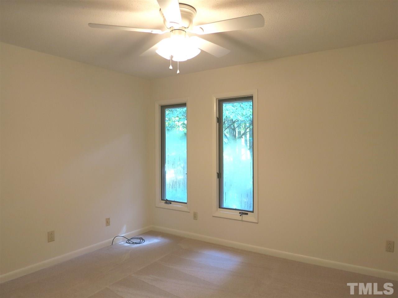 9209 Litchford Road Raleigh, NC 27615 - Photo 18 of 25 an empty room with windows and fan