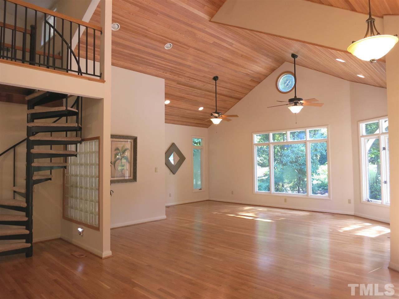 9209 Litchford Road Raleigh, NC 27615 - Photo 3 of 25 a view of an empty room with window and wooden floor