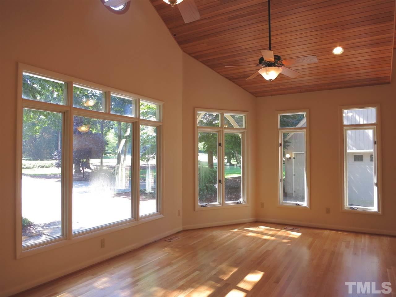 9209 Litchford Road Raleigh, NC 27615 - Photo 4 of 25 a view of an empty room with a window and wooden floor
