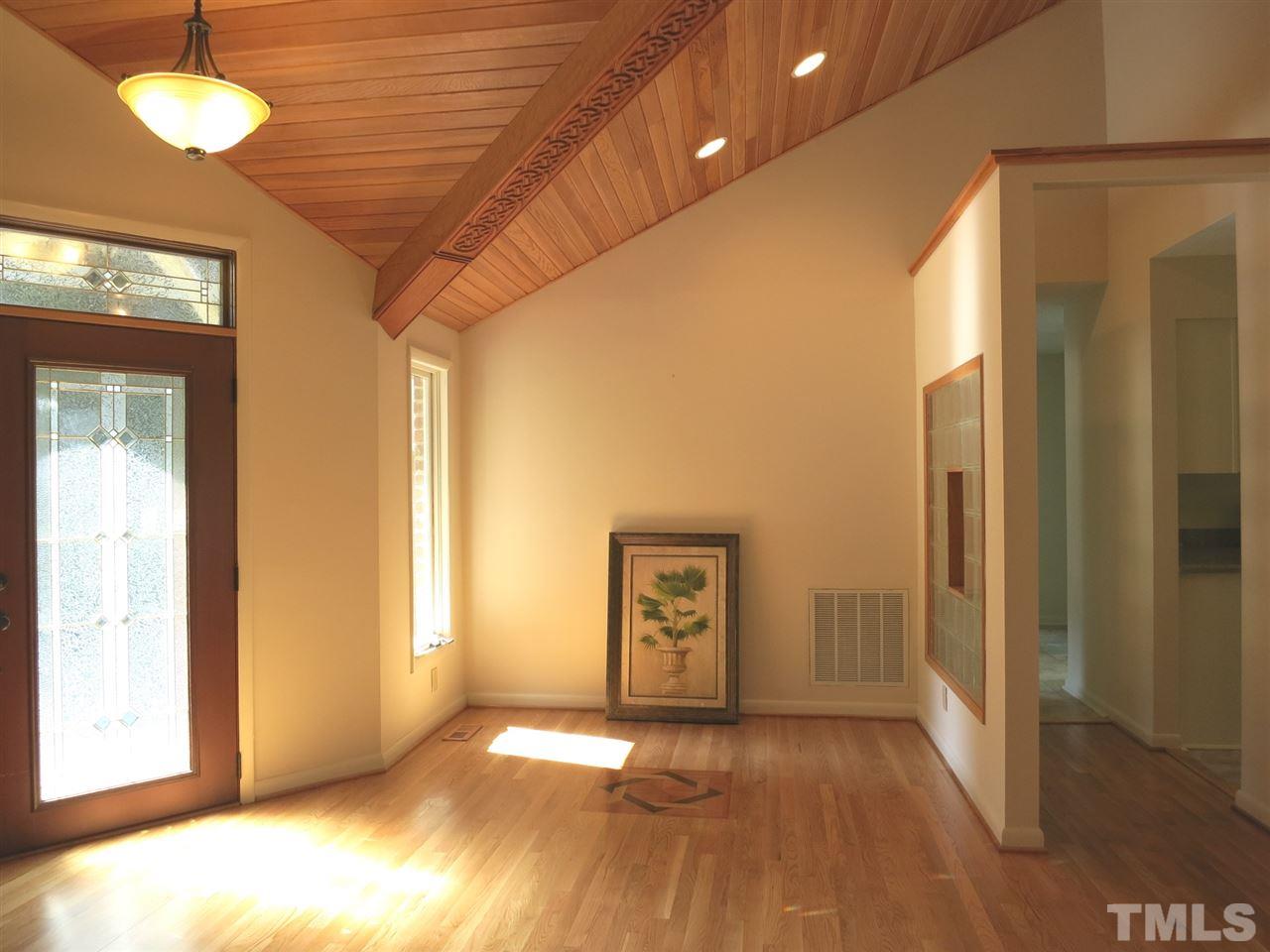 9209 Litchford Road Raleigh, NC 27615 - Photo 7 of 25 a view of an empty room with a window and wooden floor