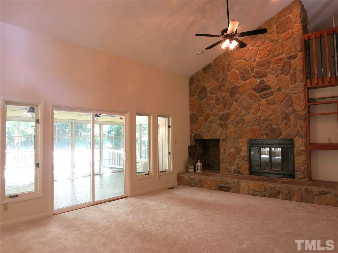 9209 Litchford Road Raleigh, NC 27615 - Photo 8 of 25 a view of a livingroom with a fireplace and window