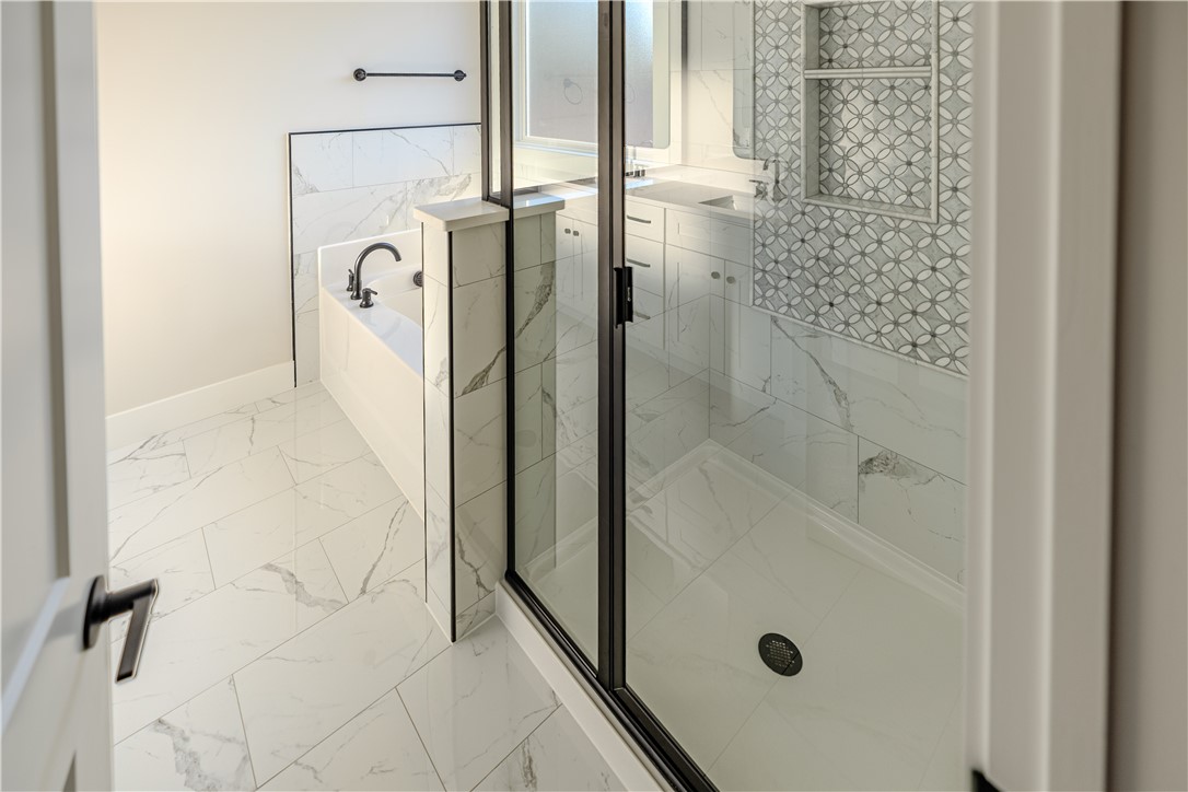 1409 Stonehurst Road Anderson, SC 29621 - Photo 12 of 37 This spacious bathroom offers a relaxing soaking tub and a sleek walk-in shower.