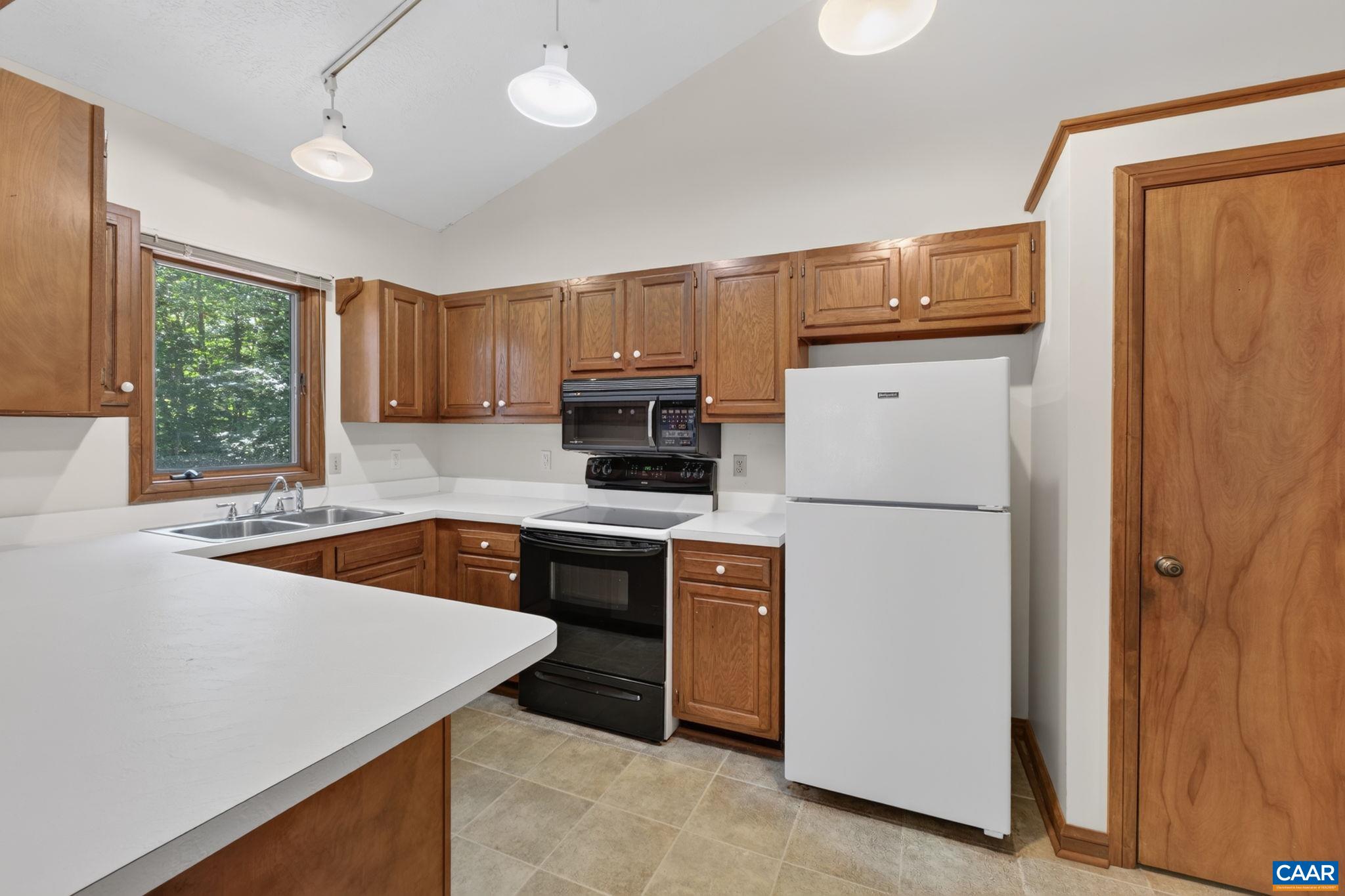 9 Timberlake Terrace Palmyra, VA 22963 - Photo 9 of 35 a kitchen with wooden cabinets and white appliances