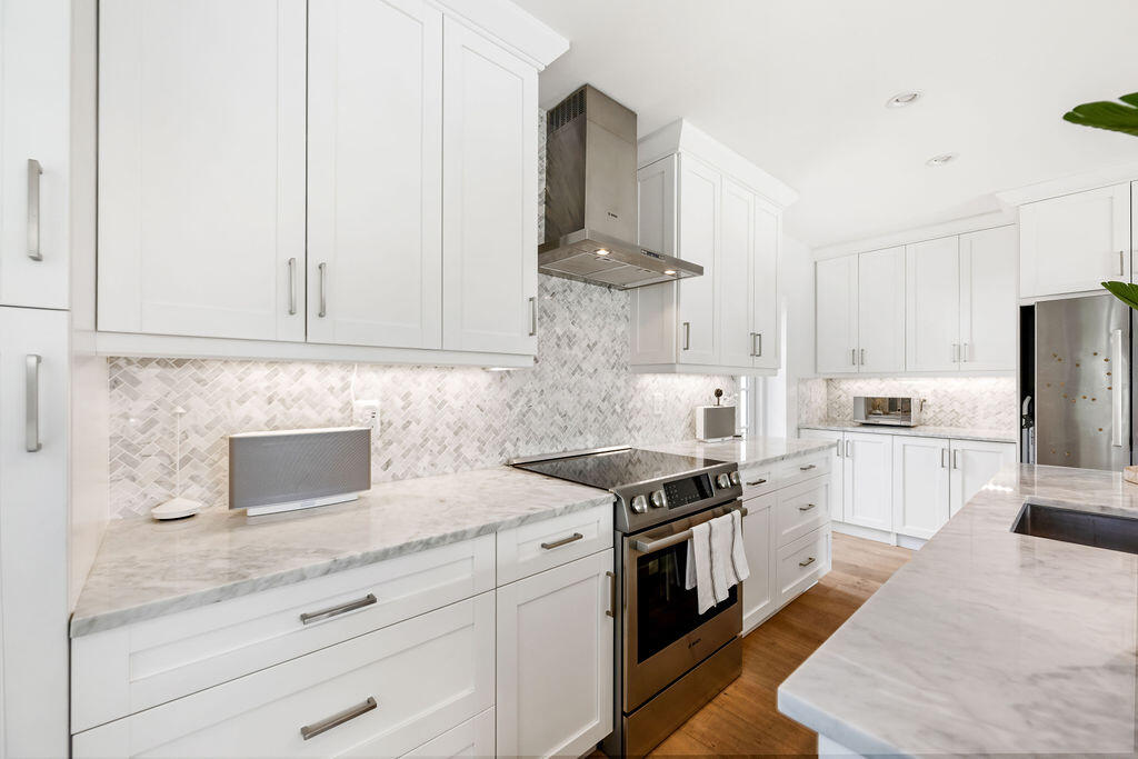 173 Peruvian Avenue, Unit 5 Palm Beach, FL 33480 - Photo 4 of 12 a kitchen with stainless steel appliances granite countertop a stove a sink and a refrigerator